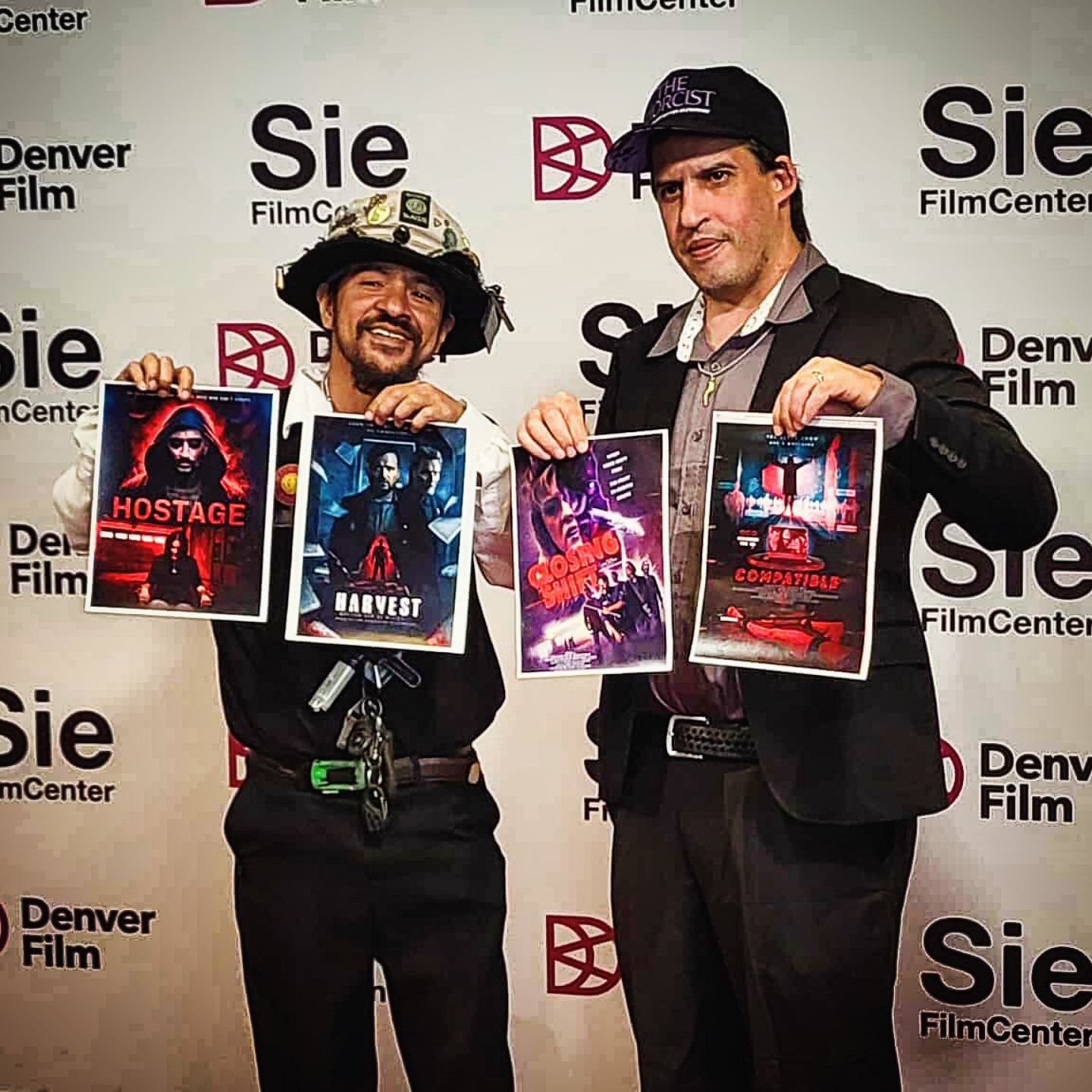 services-03 Executive Producer Perry B. Anthony with Director Gino Alfanso Sie Film Center for the premiere of Compatable the two holding 4 posters of the films Perry Executive Produced and Gino Directed